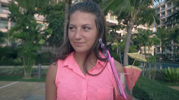 Woman in Pink Clothing with Long Hair Drinks Tasty Beverage