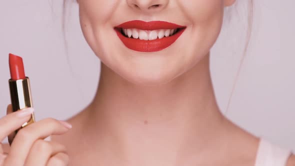 Close-up of Girl Applying Red Lipstick