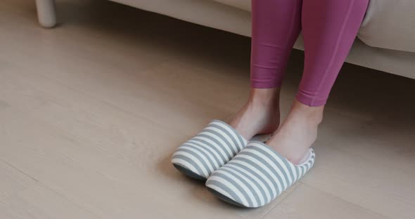 Woman wearing slipper at home