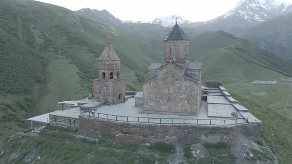 Stepantsminda, Georgia - May 8 2021: Aerial view of Gergeti Trinity Church, Tsminda Sameba. Kazbegi