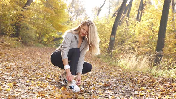 Attractive Slender Woman Ties Her Shoes Sneakers She Runs Through Autumn Forest Wears Sports Clothes