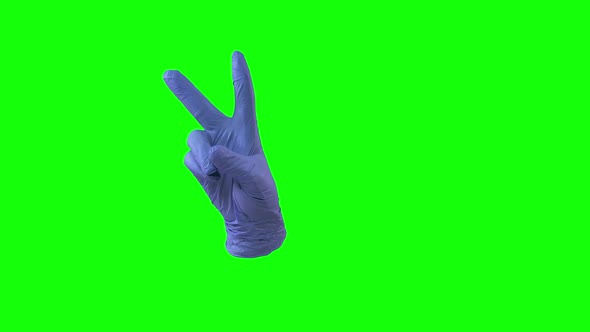 Doctors Female Hand in Blue Glove Shows Two Fingers Victory Sign. Green Screen. Close Up