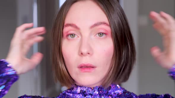 Woman Adjusts Purple Dress Short Hairstyle Near Mirror