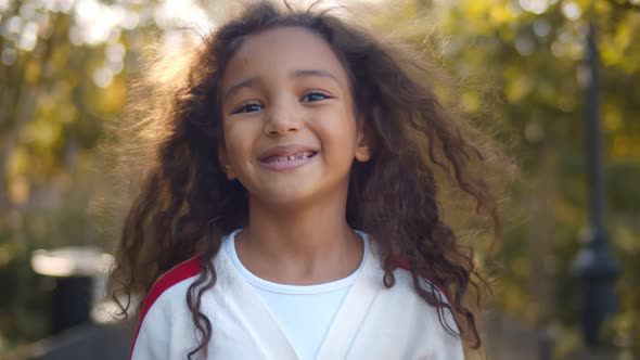 Outdoor Close Up Portrait of a Cute Young Black Girl Smiling