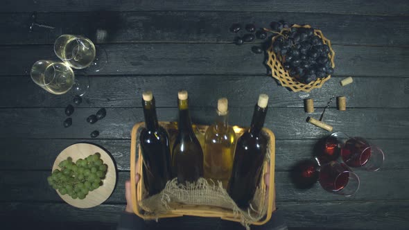 Handing over Bottles of Red and White Wine