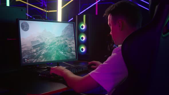 Teenager is competing in a first person multiplayer war video game tournament alt