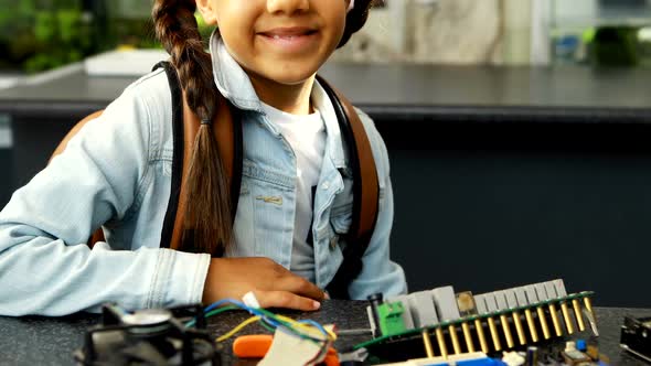 Portrait of happy schoolkid sitting in laboratory 4k