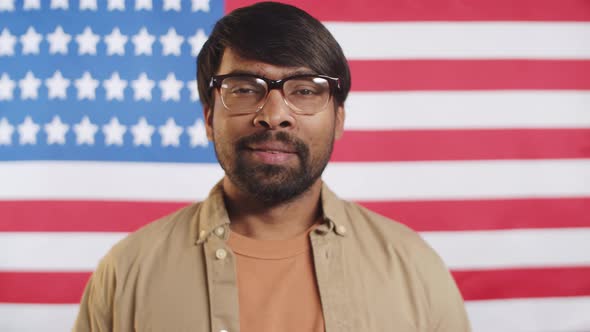 Confident Indian Man Posing for Camera against U,S, Flag