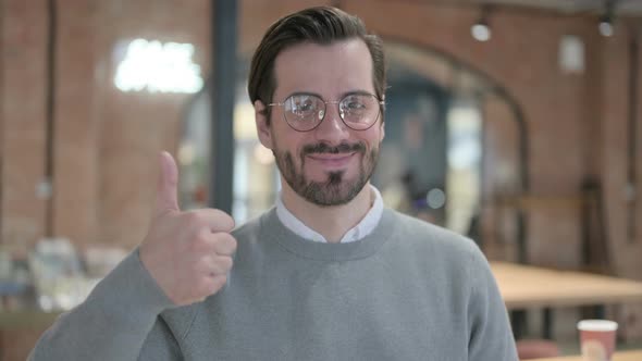 Portrait of Young Man Showing Thumbs Up Sign