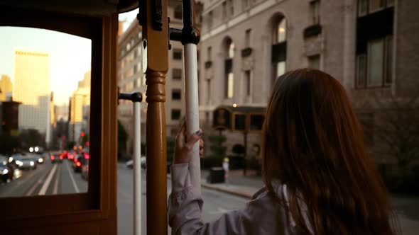 Woman using a tram on a city street