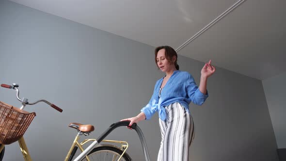 Stylish Young Brownhaired Woman Cleans the Apartment