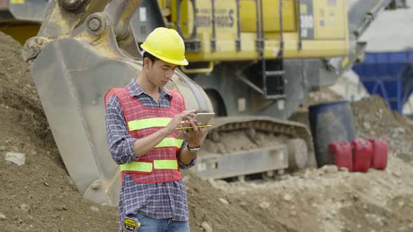 Asian Construction Worker Working With Tablet