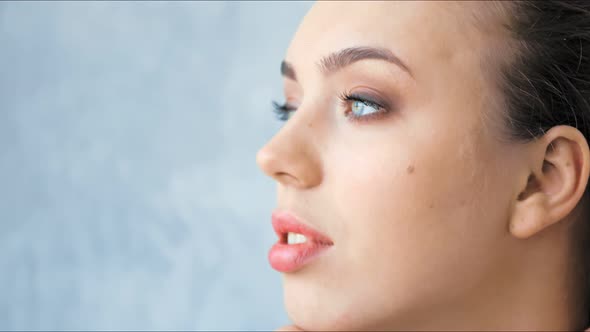 Fashion Model with Professional Beauty Makeup Posing in Studio