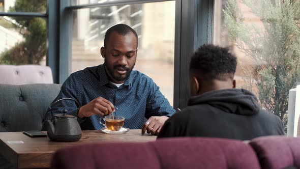 African American Man Drinking Tea in the Restaurant