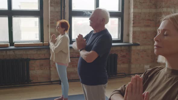 Seniors Meditating in Yoga Class