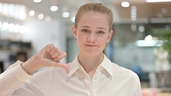 Disappointed Businesswoman Doing Thumbs Down Sign 