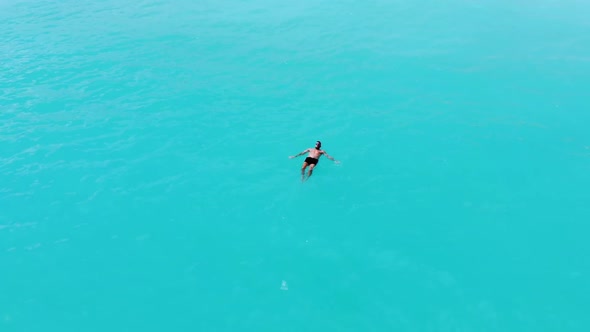 A Young Male Model Swimming Alone In the Turquoise Caribbean Sea