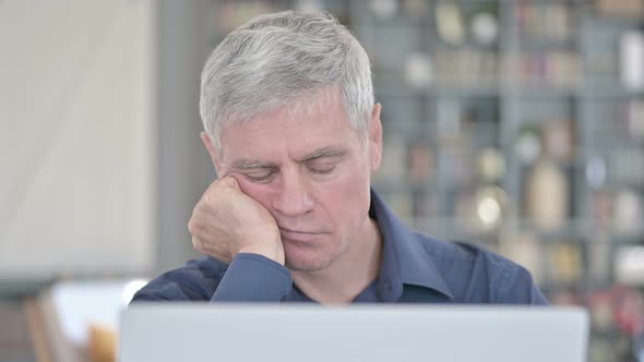 Portrait of Tired Man Having Quick Nap While Working in Office