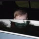 Young Boy in a Medical Mask Lowers the Glass and Looks Through the Car Window. - VideoHive Item for Sale
