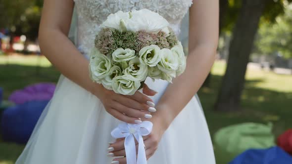 Wedding Bouquet in the Hands of a Beautiful Bride