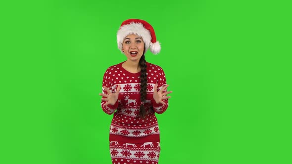 Sweety Girl in Santa Claus Hat with Shocked Surprised Wow Face Expression. Green Screen