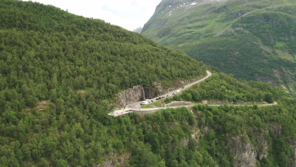 Vehicles And People At The Scenic Viewing Platform On Hillside. Ornesvingen Viewpoint In Geiranger,
