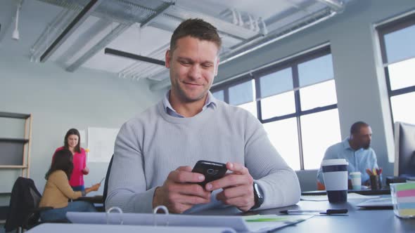 Businessman using smartphone in modern office