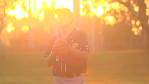 A young man playing catch with a baseball.