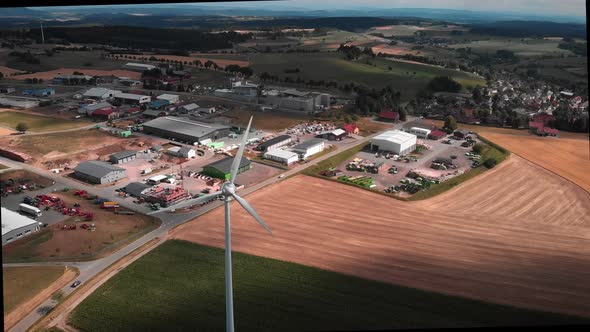 Working wind turbine against rural scene