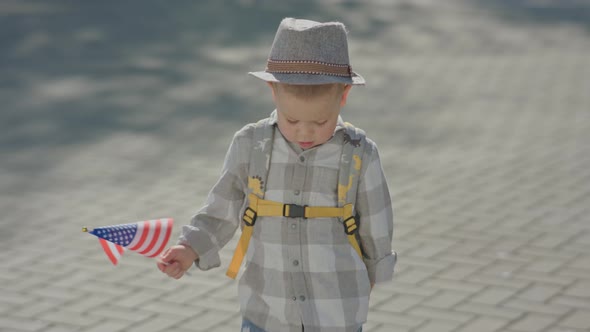 34 Year Baby Boy Kid Waving American USA Flag Marching Parade on Grey Road