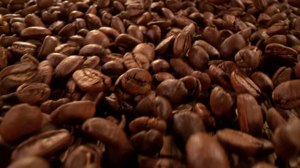 Super Slow Motion Detail Shot of Coffee Beans Strewing Towards at 1000Fps with Camera Motion