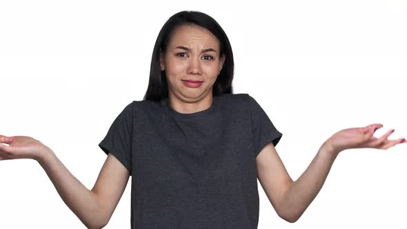 Portrait of Brunette Woman Throwing Up Hands Meaning Do Not Know Cannot Help or Have No Idea