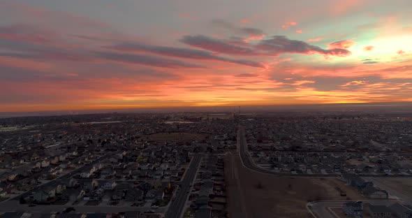 A drone flies backward revealing an epic sunrise over Northern Colorado.