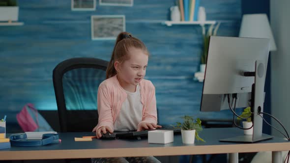 Frustrated Child Attending Online Classes on Computer