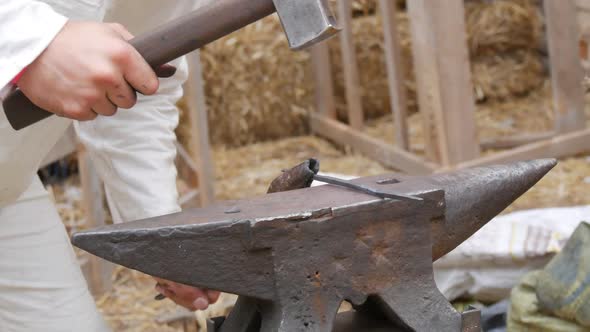 Medieval Method of Forging Iron the Blacksmith Forges an Iron Nail From the Fire