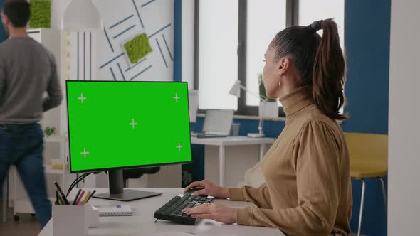 Business Woman Looking at Display with Green Screen