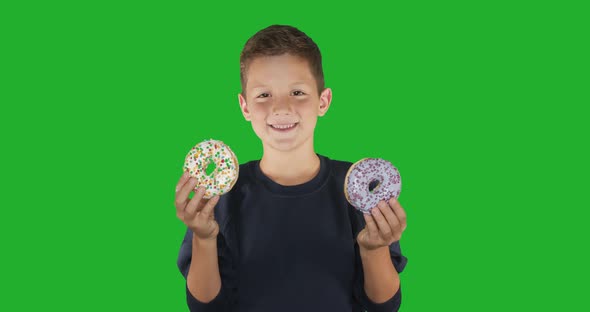 Closeup. Portrait of a Funny Guy, Having Fun with Colorful Donuts Against His Face. Expressions