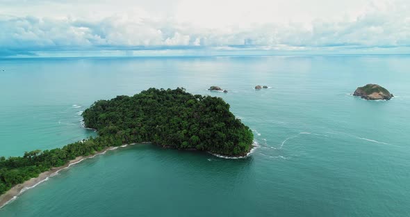 Aerial video of a part of forest/land in the sea, in Manoel Antonio , Costa Rica.