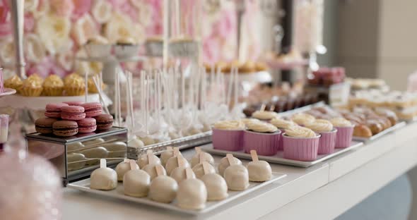 Cute Candy Bar with Various Cakes and Candies. Wedding Candybar.