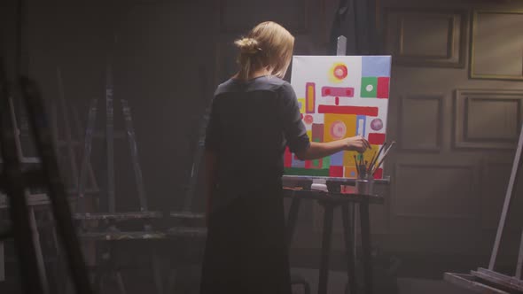 Female Painter Finishing Artwork
