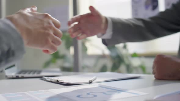 Handshake of Two Male Colleagues in Office