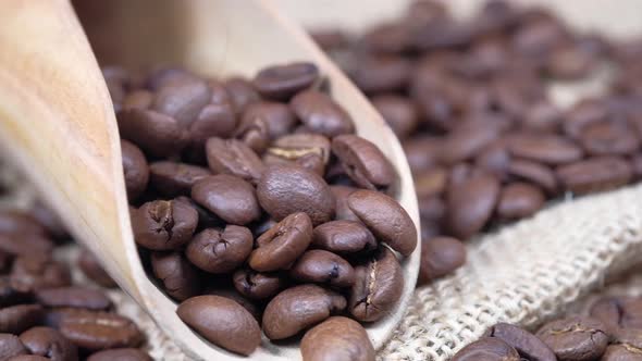 Fresh Coffee Beans and Spoon on Wooden Background 