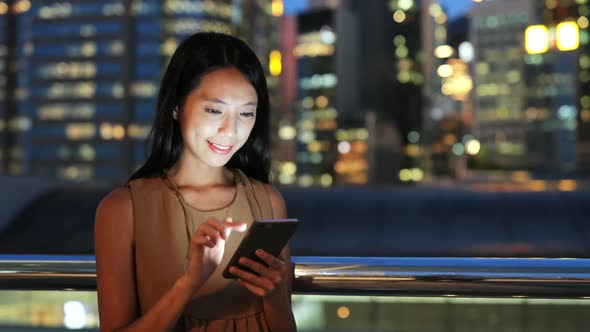 Woman use of mobile phone in city 