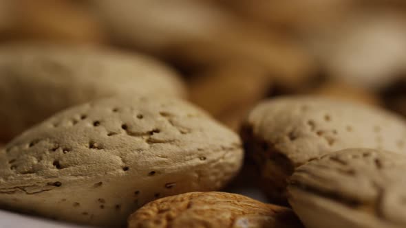 Cinematic, rotating shot of almonds on a white surface - ALMONDS