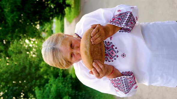 Grandmother with Ukrainian Bread in Her Hands