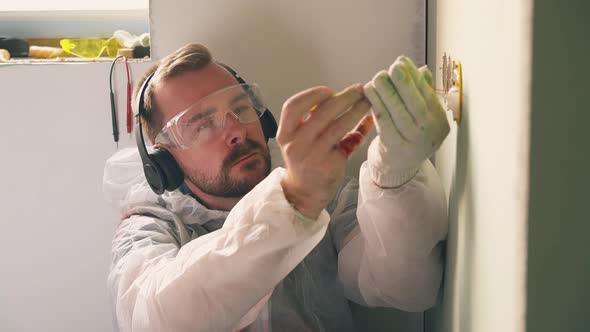 Man in Headphones Gets Electric Shock Repairing Plug