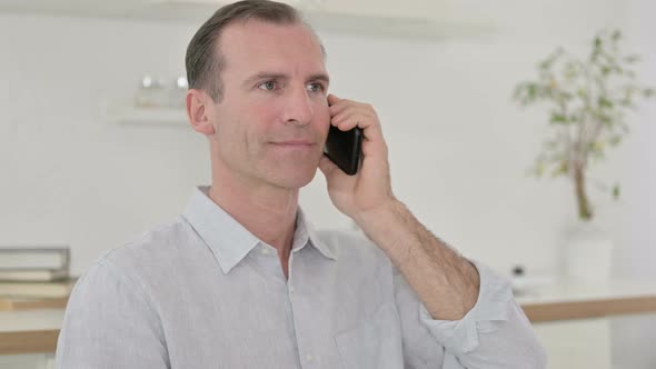 Middle Aged Man Talking on Smartphone