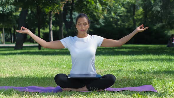 Woman Working with Laptop Sitting Lotus Pose