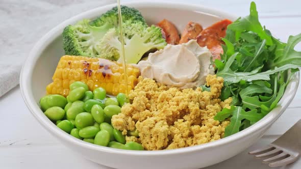 Vegan breakfast bowl - scrambled tofu, corn, beans, sweet potato and broccoli.