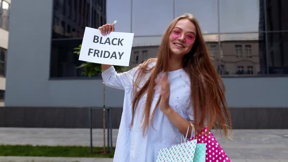 Cheerful Girl Showing Black Friday Inscription Text Advertisement. Online Shopping with Low Prices